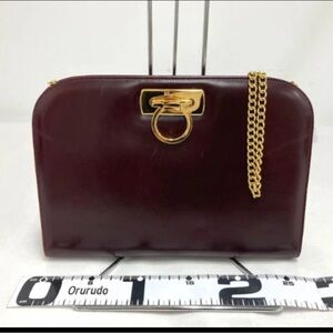 100% Authentic Salvatore Ferragamo Burgundy Clutch with Gold Chain